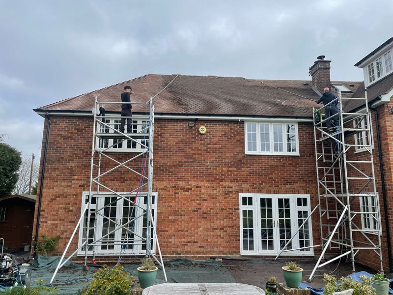Roof cleaning carried out safely from scaffold towers by The Roof Moss Cleaners in West Chiltington Common